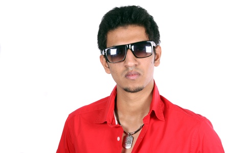 A portrait of a smart young Indian guy, isolated on white studio background.の写真素材