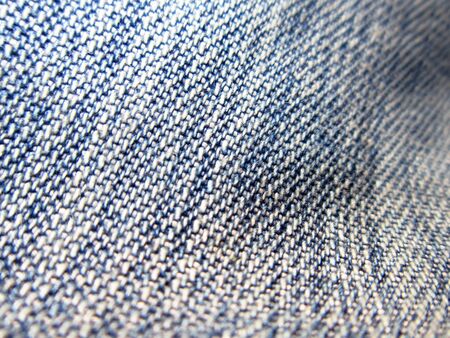 A background of an uneven blue denim fabric                                の写真素材