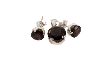 A jewelery set of pendant and earrings made of smoky quartz gemstones, isolated on white studio background の写真素材