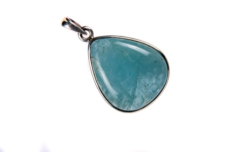 A beautiful pendant with a blue gemstone used as jewelery as well as alternative method in crystal therapy and astrology, isoalted on white studio background の写真素材
