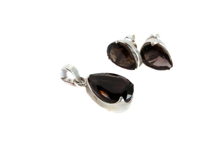 A jewelery set of pendant and earrings made of smoky quartz gemstones, isolated on white studio background  Focus on Pendantの写真素材