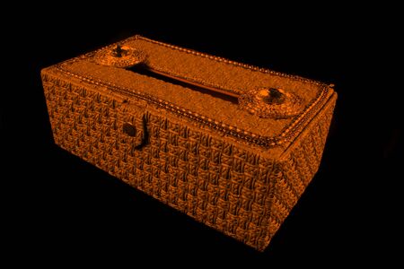 A beautiful orange colored tissue box decorated with precious jewels の写真素材