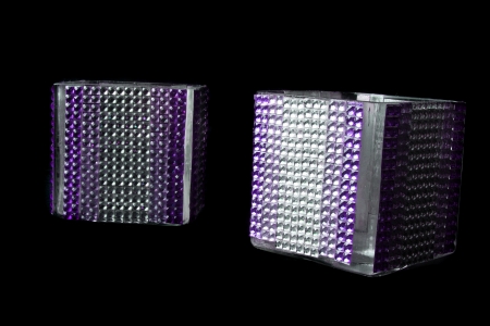 A pair of beautiful candle stands studded with artificial gemstones, on black studio background の写真素材