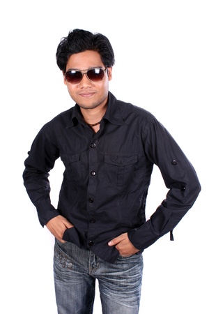 A young Indian man in black shirt wearing sunglasses, on white studio background.の写真素材