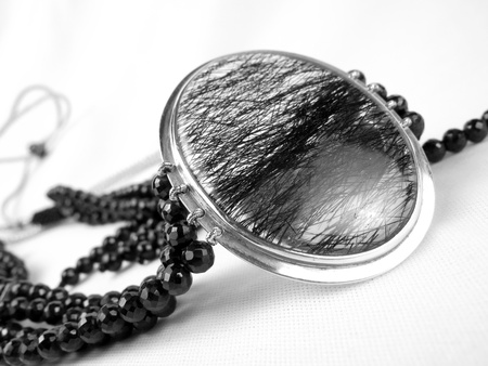 A beautiful designer necklace made of a silver pendant and black crystals                                の写真素材