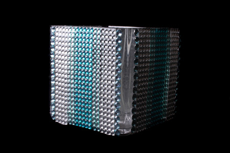 A tissue holder box studded with gems and glass beads, isolated on black background.の写真素材