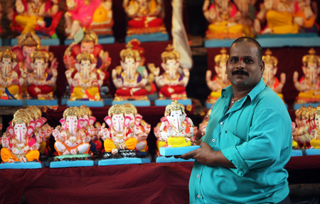 A man selling Lord Ganesh idols on the eve of Ganesh festival in India. The festival involves thousands of visitors from all over the world every year, in the main celebration city - Pune.のeditorial素材