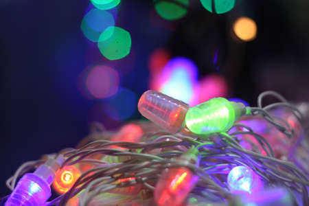 A line of colorful decorative bulbs lit on the occasion of Diwali / Christmas in Indiaの写真素材