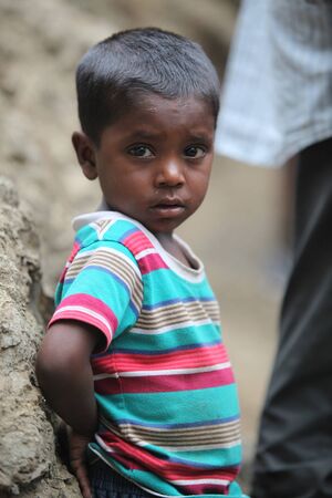 A portrait of a poor little boy from India in his unfortunate condition.の写真素材