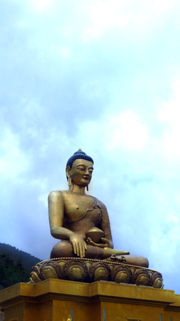 The Buddha Dordenma with the tallest statue of Buddha towering over a beautiful value in Thimpu, Bhutan.の写真素材