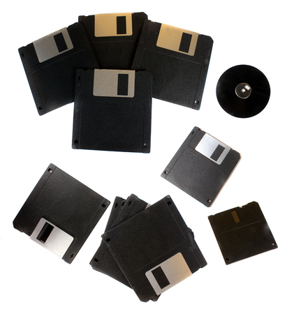 Old floppys used for computer storage in 80s and 90s, on white studio backgroundの写真素材