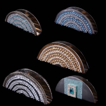 A set of coaster or tissue holders with beautiful designs, on black studio background.の写真素材