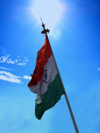 A beautiful view of the flag of India against the bright noon sunの写真素材