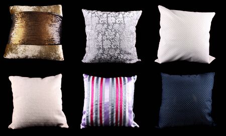 A set of square cushions made from different designs and material, on black studio background.の写真素材
