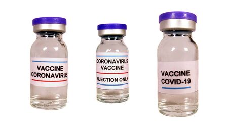 Different versions of corona virus vaccine in bottles, on white studio background.の写真素材