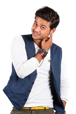 A handsome young Indian guy smiling, on white studio background.の写真素材