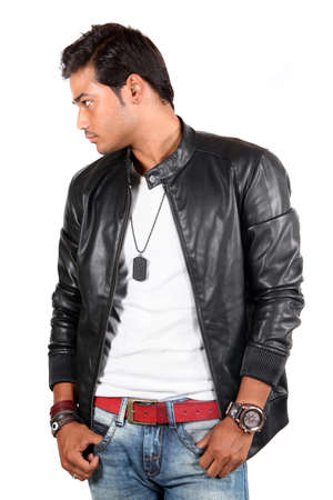 A young India male model posing in a leather jacket, on white studio background.の写真素材