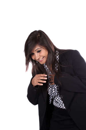 A beautiful young Indian businesswoman laughing, on white studio background.の写真素材
