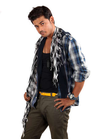 A young handsome Indian model posing in style, on white studio background.の写真素材