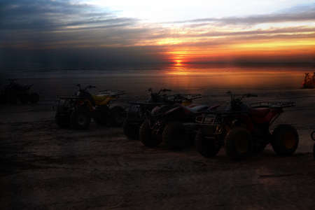 Beach Buggies parked on a beautiful beach at sunrise or sunset.の写真素材