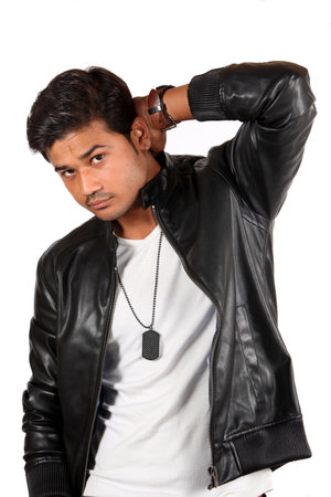 A handsome young Indian guy in a black leather jacket.の写真素材