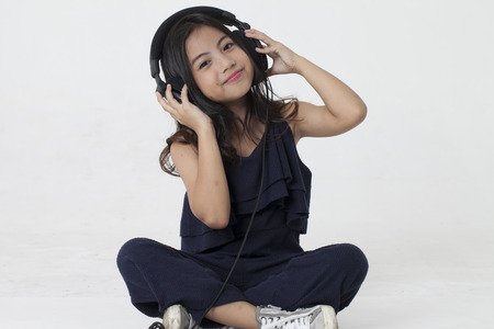 Girl listening to music on headphoneの写真素材