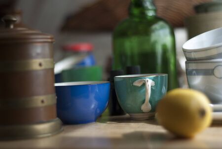 a still life of odd bits and pieces of clutter, including cups, crockery and glass の写真素材