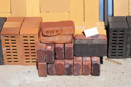 Colored building blocks, bricks  and concrete pavers (paving stone) or patio blocks organized on...