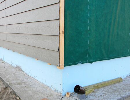 Plastic Siding Wall Construction and Insulation Membrane on House Exterior Wall.の写真素材