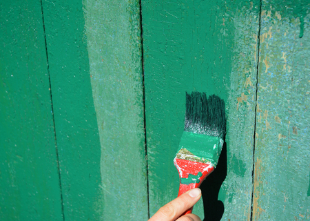 Worker hand with brush painting old wooden surface. Paint Wooden Old Door.の写真素材