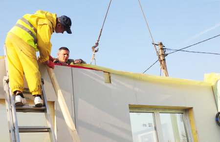 KIEV - UKRAINE APRIL - 25, 2017: Contractors Building New Frame House. Installing Frame House Structural Insulated Panel - SIP with Crane Hook. のeditorial素材