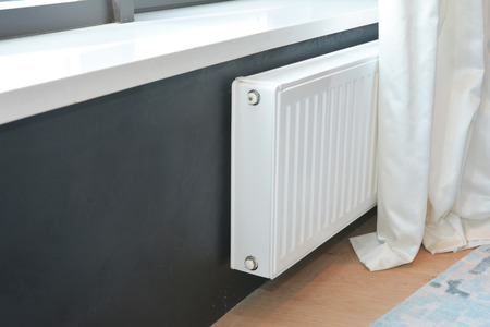 White radiator heating with thermostat for energy saving.の写真素材