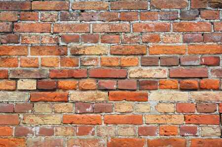 Old brick wall textured background. Vintage colorful brick house wall background.の写真素材