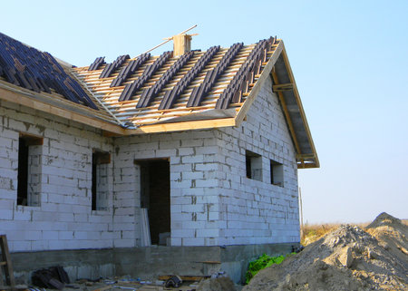 Roofing construction with clay roof tiles. Building house with ceramic roof  tiles.のeditorial素材