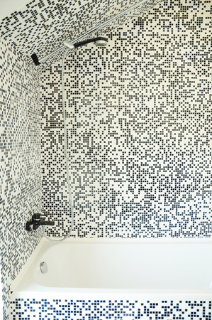 Modern bath tub with shower, chrome faucet and modern mosaic tiles