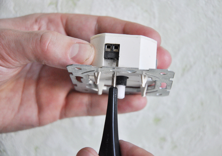 Electrician installing and repair a dimmer switch in a wall socket. Light switch dimmer.
