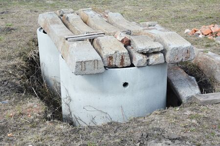 Installing concrete septic tanks. Sewer tank hole installation outdoors.の写真素材