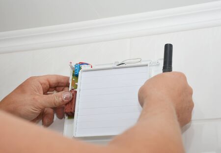 Bath fan repair, installation. Handyman installing new bath vent fan, ventilation system in the house bathroomの写真素材