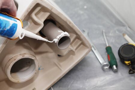 Installing toilet bowl in house bathroom.の写真素材