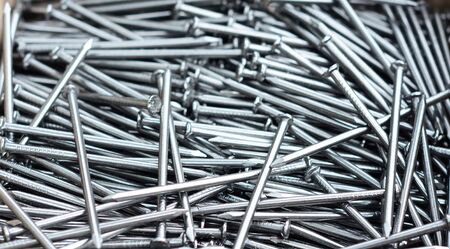 Nails pile textured background. Many nails as construction industry conceptの写真素材