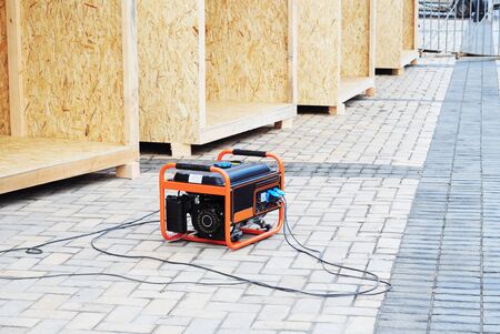 Mobile backup generator on the construction site. Standby generator - outdoor power equipment.の素材 [FY310140184900]