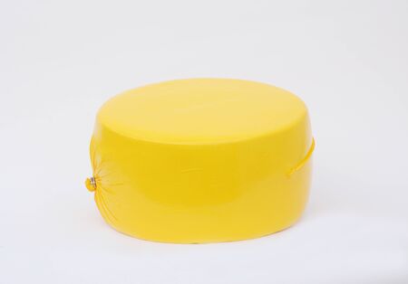 Big cheese head in yellow vacuum package. Cheese wheel isolated on white background. Packaging...
