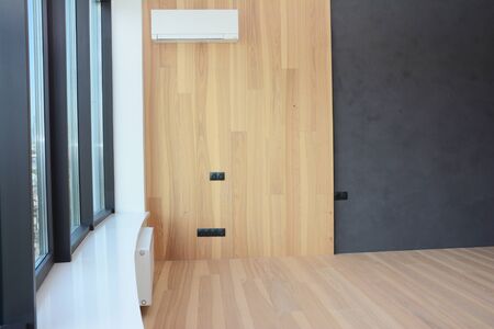 Modern house room with wooden floor and decorative wooden part of wallの写真素材