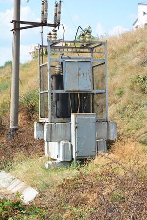 Powering the railway: a close-up on old high voltage transformer substation near the railways to...