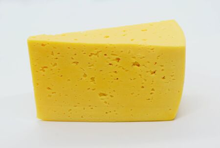 Cow's milk semi-hard cheese piece, slice of russian, sour creamy, gouda cheese isolated on white background.の写真素材