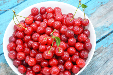 Tasty sweet ripe red cherries in a bowl as a concept of high quality vitamin food and healthy...