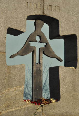 KYIV, UKRAINE - November 06, 2020: Holodomor memorial in a shape of a cross with a silhouette of a woman inside it in Mykhailivska square in Kiev, Ukraine to commemorate the victims of Famine Genocideのeditorial素材