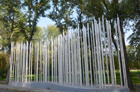 KYIV, UKRAINE - September, 22, 2021:  A new ï»¿ï»¿Babin Yar memorial monument in the form of a row of long pillars, posts installed along the path road symbolizing Jews killed during Holocaust.のeditorial素材
