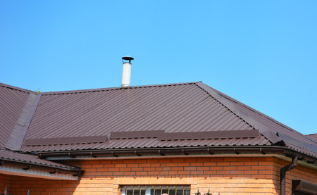Problem Areas for Roofing Rain Gutter Waterproofing. Guttering Down pipe fittings. Rain gutter system and roof protection from snow board (Snow guard) on house roofing.の写真素材