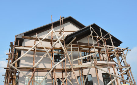 Wooden scaffolding on new house insulation construction with painting walls. Wooden frame.の写真素材